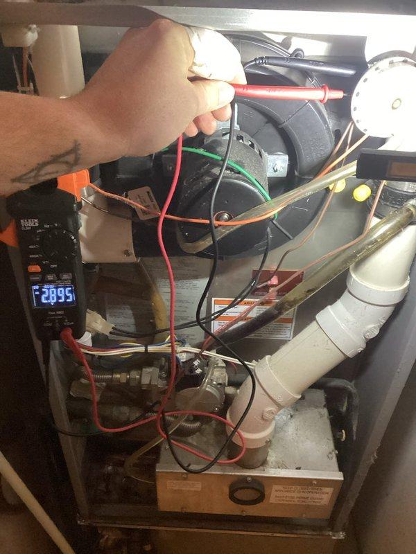 Responded to no-heat call on 15-year-old forced air furnace with reported pilot light failure and inoperative blower motor. Upon arrival, performed diagnostic testing of electrical components using digital multimeter to verify power supply and circuit continuity throughout the system. Testing revealed electrical fault preventing proper system operation. Inspected blower motor assembly, wiring connections, and control board terminals. Verified condensate drainage system and PVC piping were clear and properly configured. Restored system to full operational status with heat output confirmed before departure.
