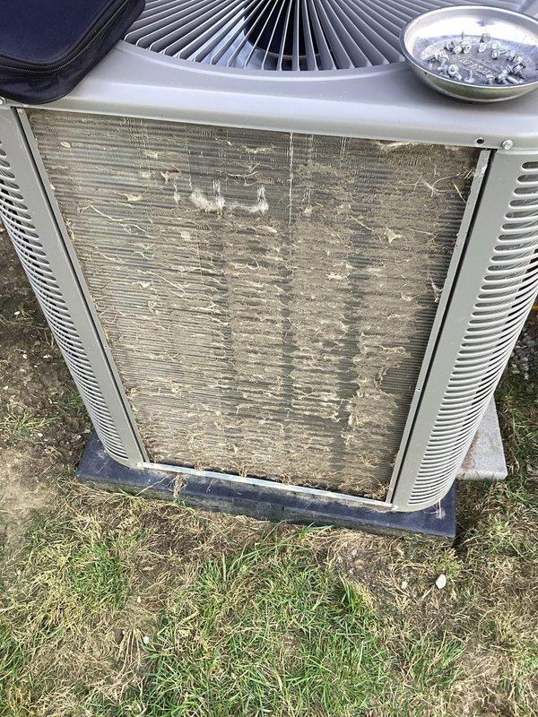 # HVAC Repair - No Cooling Issue

Responded to a no-cooling complaint on a 3-year-old Lennox central air conditioning system. Upon arrival, confirmed unit was running but delivering ambient temperature air with no cooling capacity.

## Diagnostic Findings

Conducted thorough system inspection and identified severe airflow restrictions as primary cause of cooling failure. Outdoor condenser coils found heavily contaminated with accumulated dirt, dust, and environmental debris, completely blocking airflow through fins. Indoor air filter discovered completely clogged with dense layer of dust and particulate matter, restricting return air supply to system.

## Work Performed

- Removed and replaced severely contaminated air filter
- Performed deep cleaning of outdoor condenser coil assembly using appropriate coil cleaning solution and equipment
- Cleared all debris from condenser unit exterior and surrounding area
- Verified proper airflow through both indoor and outdoor components
- Tested