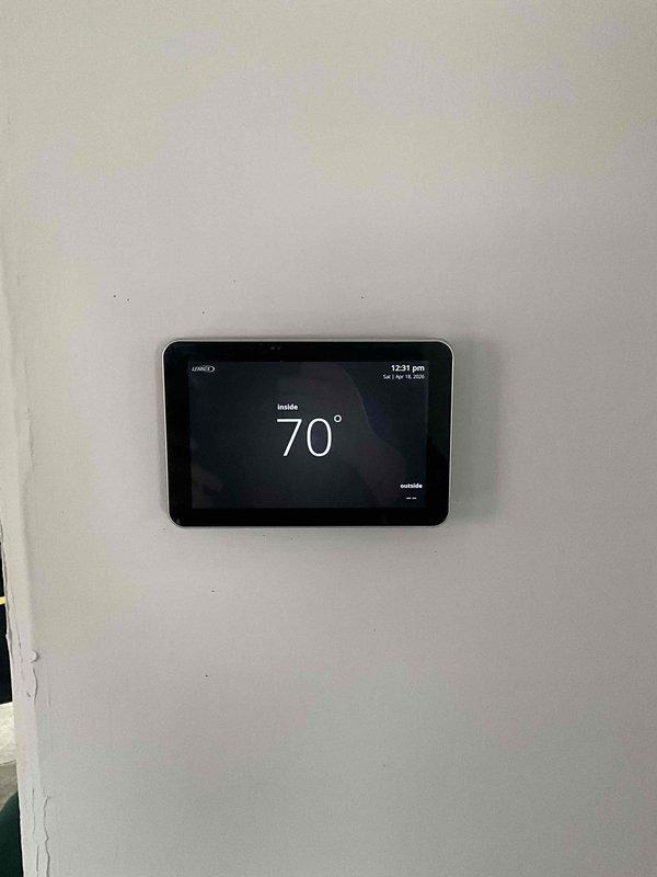 Conducted on-site assessment for new central air conditioning system installation at residential property currently without existing central AC. Evaluated home infrastructure including electrical service capacity at exterior meter location, existing thermostat wiring and placement, and potential equipment placement areas. Documented current digital thermostat configuration showing 70-degree setting and reviewed home's brick exterior construction for optimal condenser unit positioning near electrical service panel. Prepared comprehensive quote for complete central air system installation including equipment specifications, ductwork requirements, and necessary electrical upgrades.