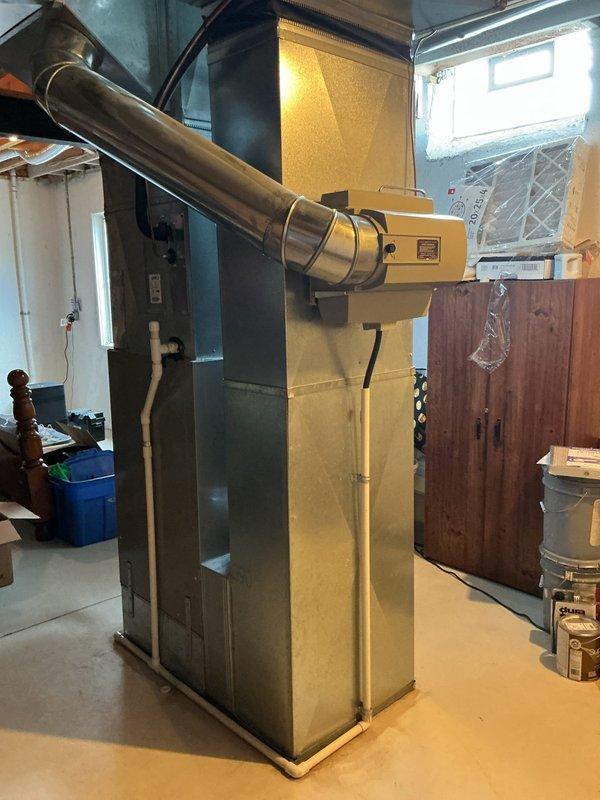 Responded to no-heat emergency call for 22-year-old furnace that had shut down due to burning smell. Upon arrival, inspected the yellow-cased furnace unit and associated ductwork system in basement utility area. Documented existing equipment condition through photographs showing the aged heating system with gray ductwork, exposed electrical components, and surrounding mechanical infrastructure. Given the unit's age beyond typical service life, safety concerns from the reported burning odor, and urgent heating needs with cold weather approaching, provided replacement estimate as requested. System remains offline pending customer decision on replacement due to safety concerns associated with the burning smell at shutdown.