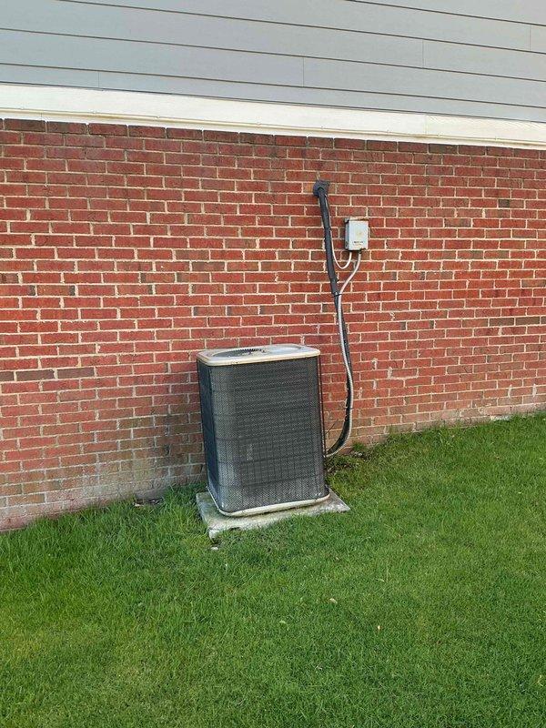 Conducted comprehensive full system HVAC evaluation for residential property with 16-year-old existing equipment. Assessed outdoor condensing unit positioned on concrete pad against brick exterior wall, including electrical disconnect and conduit routing. Evaluated indoor furnace installation located in unfinished ceiling space with existing ductwork and ventilation infrastructure. Provided complete system replacement estimate to address aging equipment, with customer requesting installation within the next couple weeks.