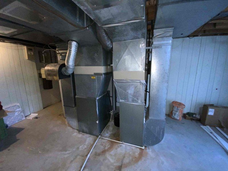 Conducted comprehensive assessment of 40-year-old non-operational HVAC system located in basement mechanical room. Evaluated existing natural gas furnace, air conditioning unit, and associated ductwork infrastructure to provide complete replacement estimate. Documented current equipment condition, measured existing ductwork configuration including flexible and rigid metal ducts, assessed electrical and gas connections, and determined optimal replacement specifications for dual furnace and air conditioning system installation.