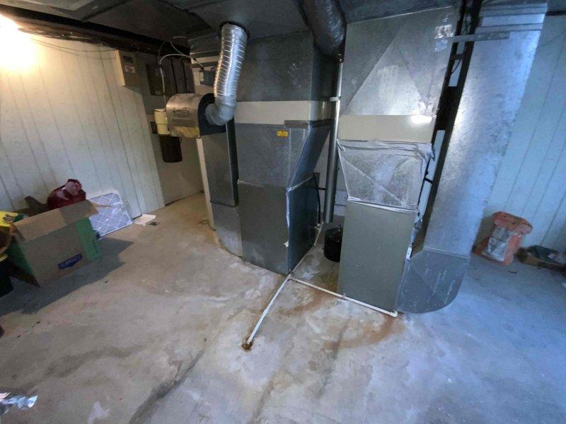 Conducted comprehensive assessment of 40-year-old non-operational HVAC system located in basement mechanical room. Evaluated existing natural gas furnace, air conditioning unit, and associated ductwork infrastructure to provide complete replacement estimate. Documented current equipment condition, measured existing ductwork configuration including flexible and rigid metal ducts, assessed electrical and gas connections, and determined optimal replacement specifications for dual furnace and air conditioning system installation.