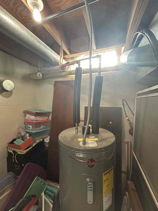 Conducted on-site estimate for tankless natural gas water heater installation in basement utility room. Assessed existing Rheem Performance conventional tank water heater and evaluated current natural gas infrastructure to determine feasibility of connecting new tankless unit alongside recently installed natural gas grill. Photographed existing water heater configuration, including flexible gas connectors, venting arrangement, and surrounding utility connections. Inspected electrical panel capacity and breaker configuration to verify adequate power supply for tankless unit's electronic ignition and control systems. Evaluated existing gas line sizing, routing, and capacity to support simultaneous operation of proposed tankless water heater and new outdoor grill. Assessed basement mechanical room layout, clearance requirements, and optimal placement for tankless installation considering combustion air requirements, venting pathways, and accessibility for maintenance. Documented current p