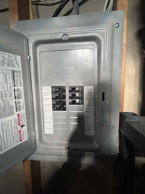 Conducted on-site estimate for tankless natural gas water heater installation in basement utility room. Assessed existing Rheem Performance conventional tank water heater and evaluated current natural gas infrastructure to determine feasibility of connecting new tankless unit alongside recently installed natural gas grill. Photographed existing water heater configuration, including flexible gas connectors, venting arrangement, and surrounding utility connections. Inspected electrical panel capacity and breaker configuration to verify adequate power supply for tankless unit's electronic ignition and control systems. Evaluated existing gas line sizing, routing, and capacity to support simultaneous operation of proposed tankless water heater and new outdoor grill. Assessed basement mechanical room layout, clearance requirements, and optimal placement for tankless installation considering combustion air requirements, venting pathways, and accessibility for maintenance. Documented current p