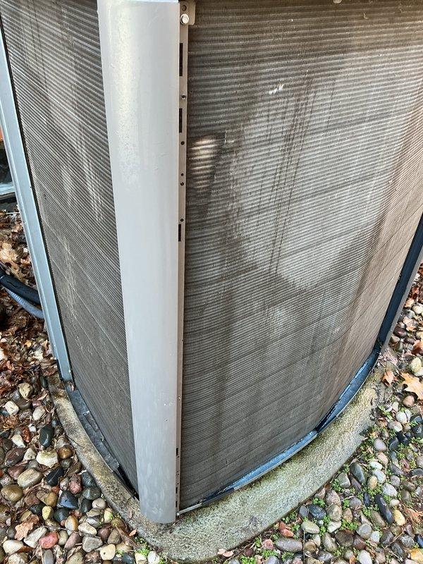 Completed routine Air Care Cooling maintenance on residential HVAC system. Inspected outdoor condensing unit, noting accumulated dirt and debris on heat exchanger coils and surrounding area; coils showed weathering and streaking consistent with normal outdoor exposure. Unit operational and positioned on concrete pad with landscaping rock perimeter.