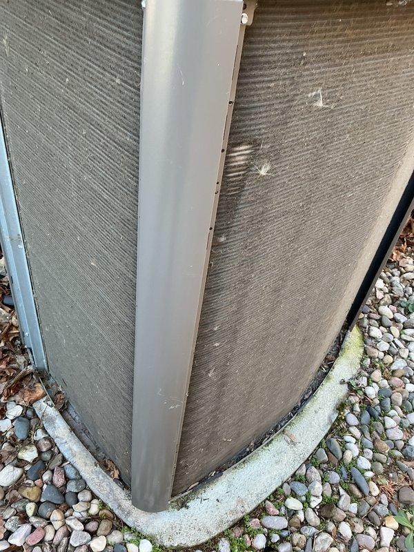 Completed routine Air Care Cooling maintenance on residential HVAC system. Inspected outdoor condensing unit, noting accumulated dirt and debris on heat exchanger coils and surrounding area; coils showed weathering and streaking consistent with normal outdoor exposure. Unit operational and positioned on concrete pad with landscaping rock perimeter.