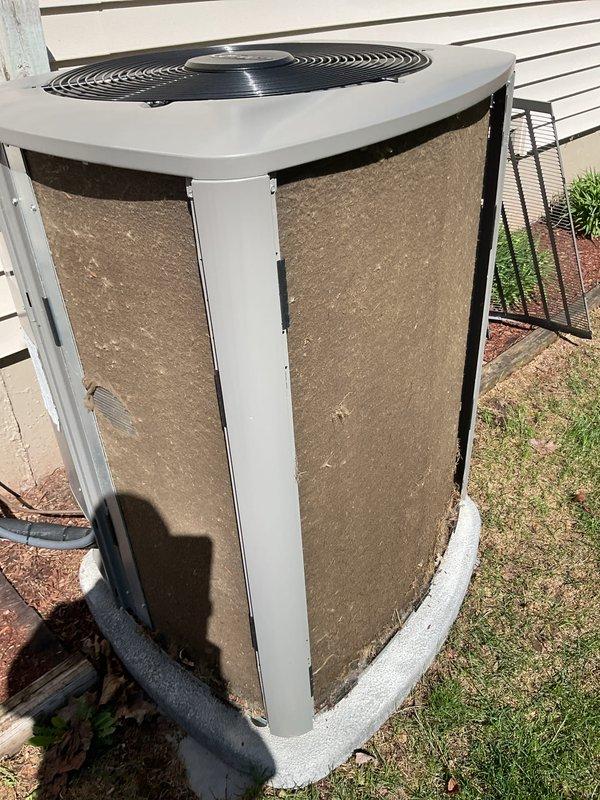 Completed annual cooling maintenance on residential air conditioning system. Replaced air filter and inspected condenser unit, which showed heavy accumulation of dirt and debris on exterior coils and fins requiring attention. Documented equipment condition with photographs showing significant contamination buildup that may impact system efficiency and airflow if not addressed through professional coil cleaning.