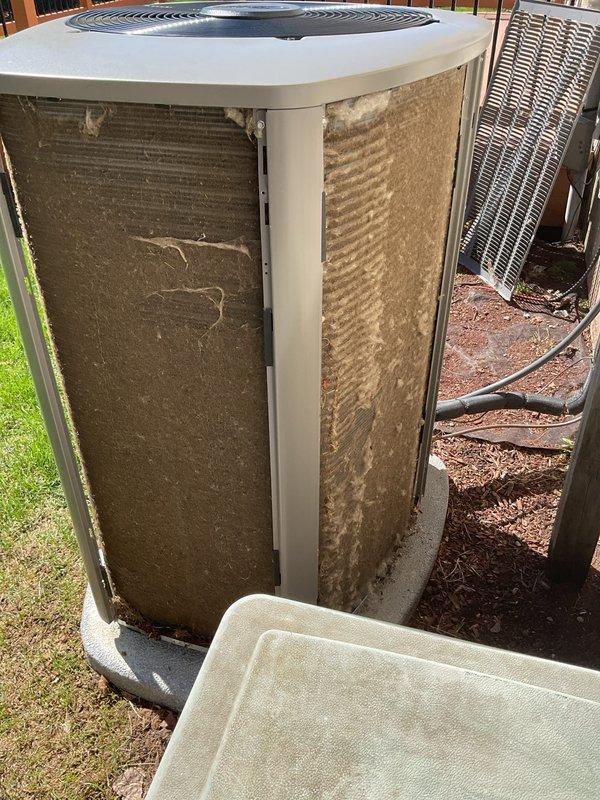 Completed annual cooling maintenance on residential air conditioning system. Replaced air filter and inspected condenser unit, which showed heavy accumulation of dirt and debris on exterior coils and fins requiring attention. Documented equipment condition with photographs showing significant contamination buildup that may impact system efficiency and airflow if not addressed through professional coil cleaning.