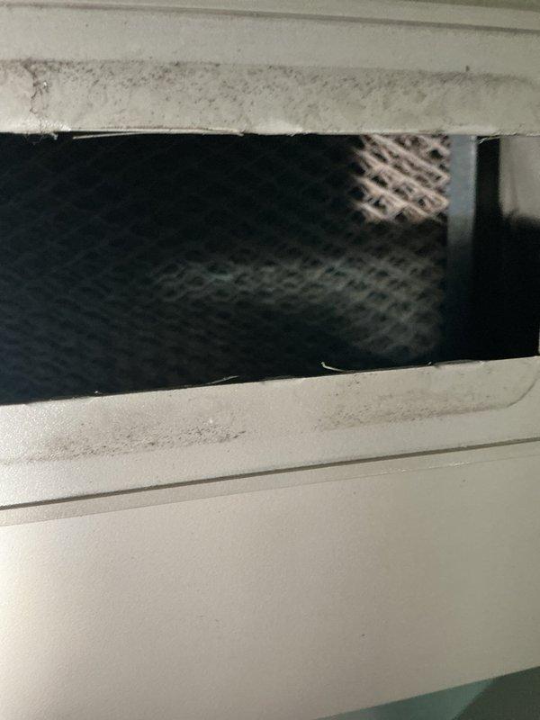 Completed annual cooling maintenance on residential HVAC system. Inspected air return vent and filter assembly, noting dust accumulation on vent cover and surrounding surfaces. Replaced air filters and evaporative cooler pads as scheduled for routine maintenance service.