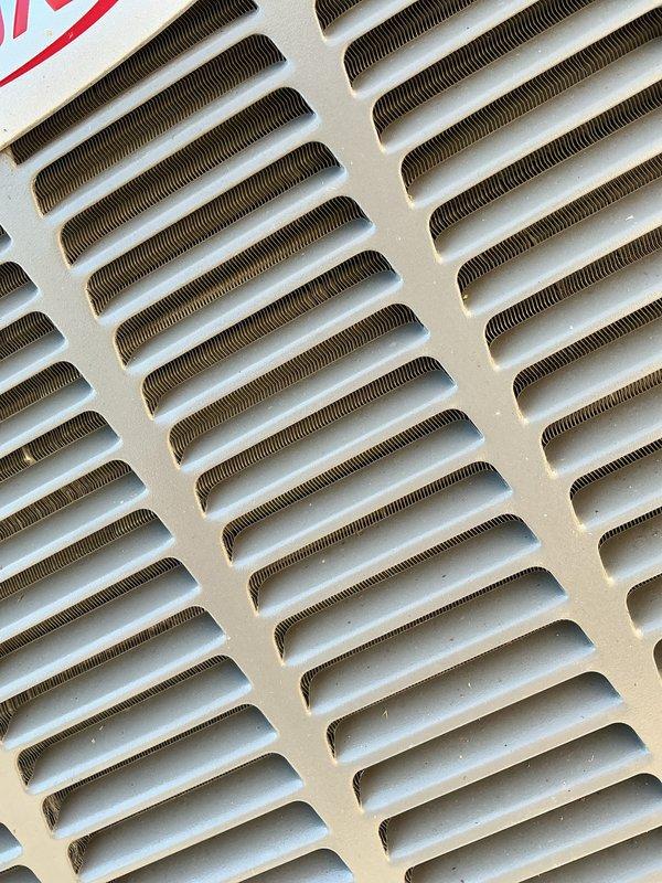 Completed annual cooling maintenance on residential HVAC system. Inspected air return vent and filter assembly, noting dust accumulation on vent cover and surrounding surfaces. Replaced air filters and evaporative cooler pads as scheduled for routine maintenance service.