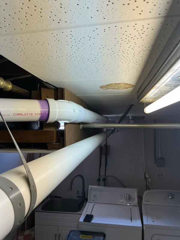 Completed callback inspection on recently installed 70,000 BTU furnace and 2-ton air conditioning system. Verified proper installation of PVC venting system with purple primer markings throughout vertical and horizontal runs, confirmed secure mounting of all ductwork and mechanical components in utility space. Noted potential combustion air deficiency requiring follow-up assessment to ensure adequate ventilation for safe furnace operation per code requirements.