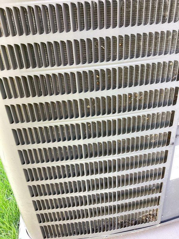 Performed annual cooling maintenance on outdoor air conditioning condenser unit. Inspected heat exchanger fins and coils, noting minor dirt and debris accumulation between louvers consistent with normal outdoor exposure. Unit operational and all components functioning within normal parameters at time of service.