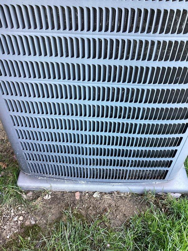 Performed annual cooling maintenance on outdoor air conditioning condenser unit. Inspected heat exchanger fins and coils, noting minor dirt and debris accumulation between louvers consistent with normal outdoor exposure. Unit operational and all components functioning within normal parameters at time of service.