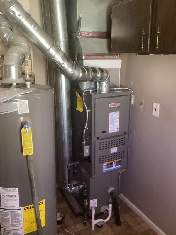 Completed installation of Lennox 70,000 BTU gas furnace in residential utility room. Performed mechanical and electrical connections, installed metal supply ductwork with proper transitions and elbows, ran copper refrigerant lines with secure mounting brackets, and connected white PVC condensate drain lines. Reconnected all existing duct connections and verified proper clearances around unit. All equipment tested and operational upon completion.