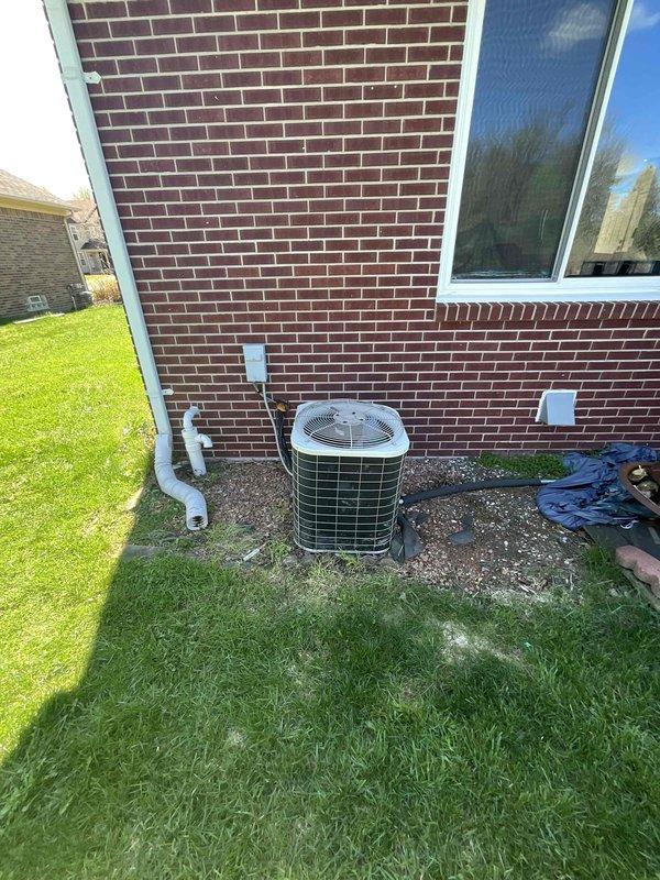 Provided comprehensive estimate for replacement of 22-year-old air conditioning system currently located at exterior of residence on concrete pad adjacent to brick foundation. Existing unit remains operational but has reached end of expected service life. Assessment included evaluation of current outdoor condenser unit, electrical service connections, refrigerant line set, and condensate drainage system routed along exterior wall. Reviewed basement-located natural gas furnace for compatibility with proposed air conditioning replacement to ensure proper system integration and optimal performance of complete HVAC system.
