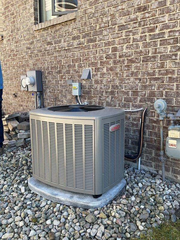 Completed full HVAC system installation including a 110,000 BTU gas furnace and 4-ton Lennox air conditioning unit positioned on right side of residence. Installed new humidifier and reconnected all existing utilities. Set outdoor condenser unit on concrete pad with proper clearances against brick exterior, installed electrical disconnect box and connected refrigerant lines. Ran new PVC vent piping through exterior wall for furnace exhaust and intake. Verified all mechanical and electrical connections, tested system operation, and confirmed proper airflow and refrigerant charge. Collected necessary documentation for utility rebate processing through DTE and SEMCO Energy programs.