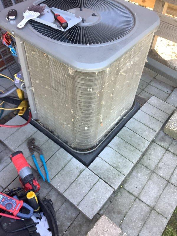 Performed routine air conditioning maintenance on outdoor cylindrical condenser unit. Conducted comprehensive system inspection, checked refrigerant lines and electrical connections, cleaned fan assembly and exterior coils, and verified proper operation of all components. Unit tested successfully with all parameters within normal operating range.
