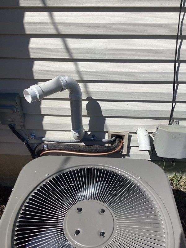 Completed full HVAC system installation including a 70,000 BTU furnace and 2-ton air conditioning unit with rear discharge configuration. Installed refrigerant lines with proper insulation, PVC condensate drain system with exterior wall mounting, and electrical disconnect box. Connected all mechanical, electrical, and refrigerant components per code requirements, with permits obtained for mechanical and electrical work prior to installation.