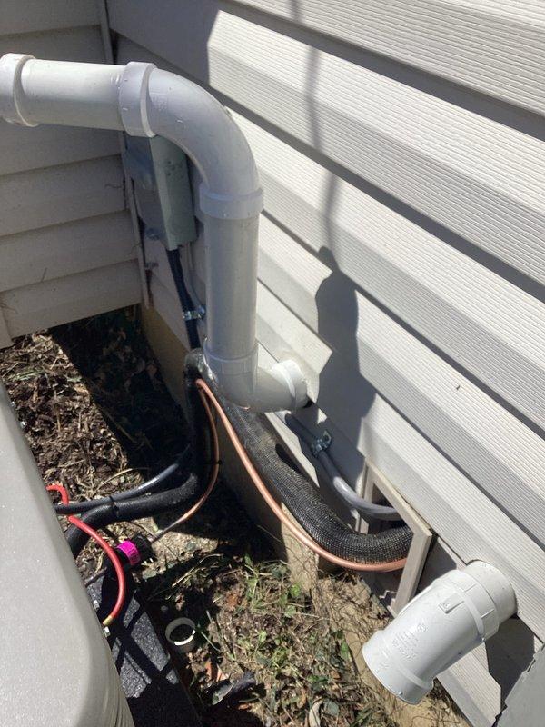 Completed full HVAC system installation including a 70,000 BTU furnace and 2-ton air conditioning unit with rear discharge configuration. Installed refrigerant lines with proper insulation, PVC condensate drain system with exterior wall mounting, and electrical disconnect box. Connected all mechanical, electrical, and refrigerant components per code requirements, with permits obtained for mechanical and electrical work prior to installation.