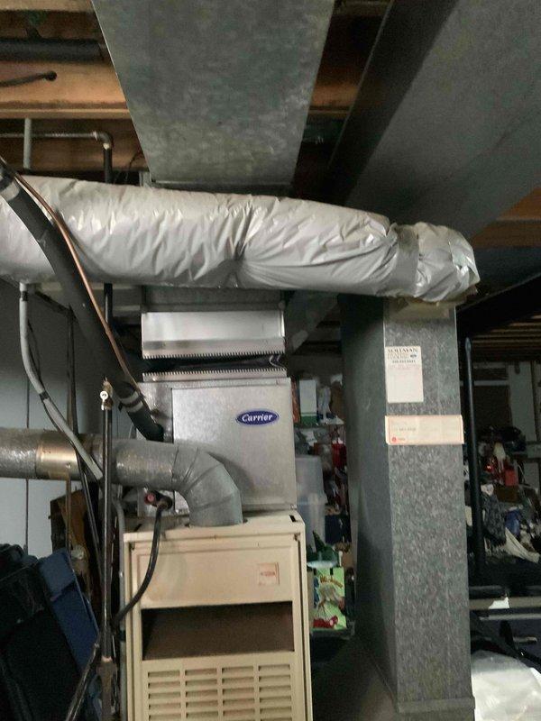Provided estimate for complete HVAC system replacement in basement location, including natural gas furnace and air conditioning unit. Existing 20-year-old Carrier system evaluated with non-functional air conditioner experiencing refrigerant leak. Assessed current equipment configuration, ductwork connections, electrical requirements, and mechanical room layout to determine optimal replacement specifications for new heating and cooling system.