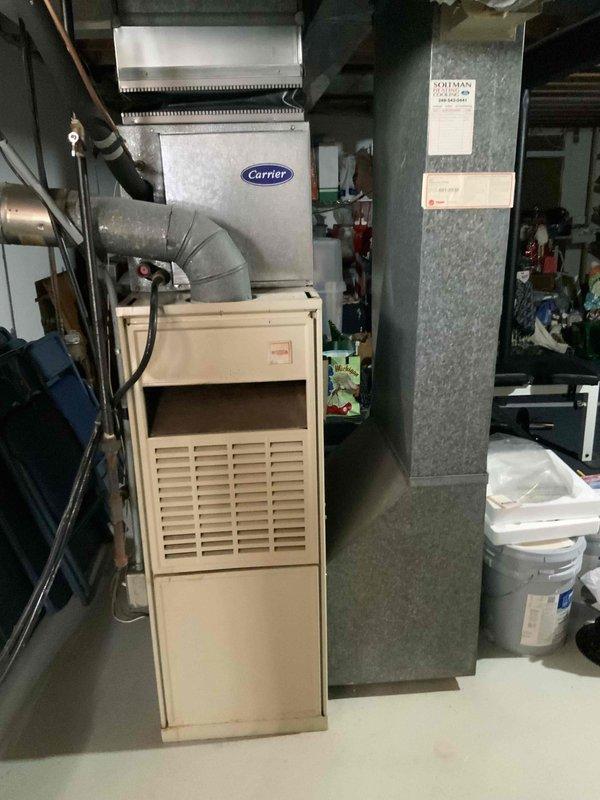 Provided estimate for complete HVAC system replacement in basement location, including natural gas furnace and air conditioning unit. Existing 20-year-old Carrier system evaluated with non-functional air conditioner experiencing refrigerant leak. Assessed current equipment configuration, ductwork connections, electrical requirements, and mechanical room layout to determine optimal replacement specifications for new heating and cooling system.