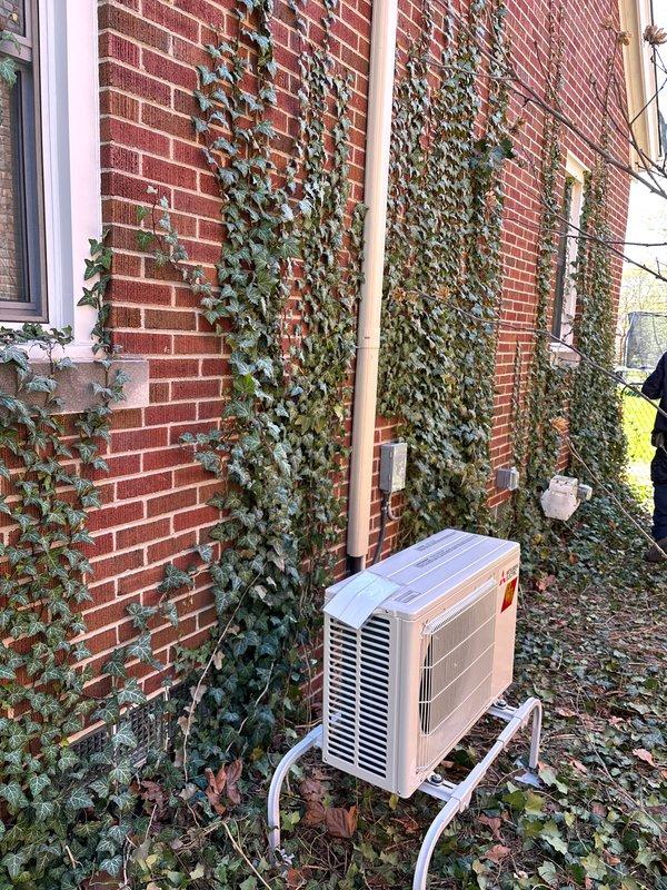 Completed full mini split system installation at residential property with mechanical and electrical permits in place. Installed outdoor condenser unit on wall-mounted bracket on exterior brick wall with proper refrigerant line set and condensate drainage. Established new dedicated electrical circuit to code specifications for system operation, with indoor air handler placement and all connections verified for proper function.