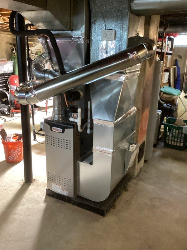 Completed full HVAC system installation including a 70,000 BTU furnace and 2-ton air conditioning unit in basement utility area. Installed new ductwork with metallic plenum connections, stainless steel venting system with proper mounting brackets and support piping, and flexible duct transitions. Performed electrical reconnection for both heating and cooling systems. Applied for and obtained mechanical, electrical, and furnace permits prior to installation. Installed liner as specified and ensured all connections meet code requirements. System positioned on platform base with proper clearances for service access. All ductwork secured with appropriate fasteners and sealed at connection points. Verified proper airflow distribution throughout supply system and confirmed equipment operational status upon completion.