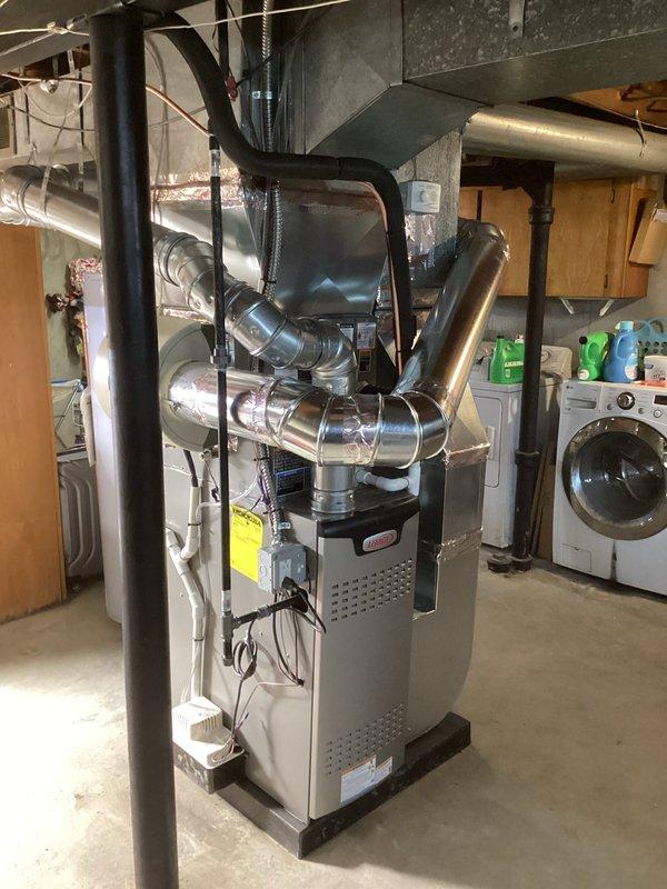 Completed full HVAC system installation including a 70,000 BTU furnace and 2-ton air conditioning unit in basement utility area. Installed new ductwork with metallic plenum connections, stainless steel venting system with proper mounting brackets and support piping, and flexible duct transitions. Performed electrical reconnection for both heating and cooling systems. Applied for and obtained mechanical, electrical, and furnace permits prior to installation. Installed liner as specified and ensured all connections meet code requirements. System positioned on platform base with proper clearances for service access. All ductwork secured with appropriate fasteners and sealed at connection points. Verified proper airflow distribution throughout supply system and confirmed equipment operational status upon completion.