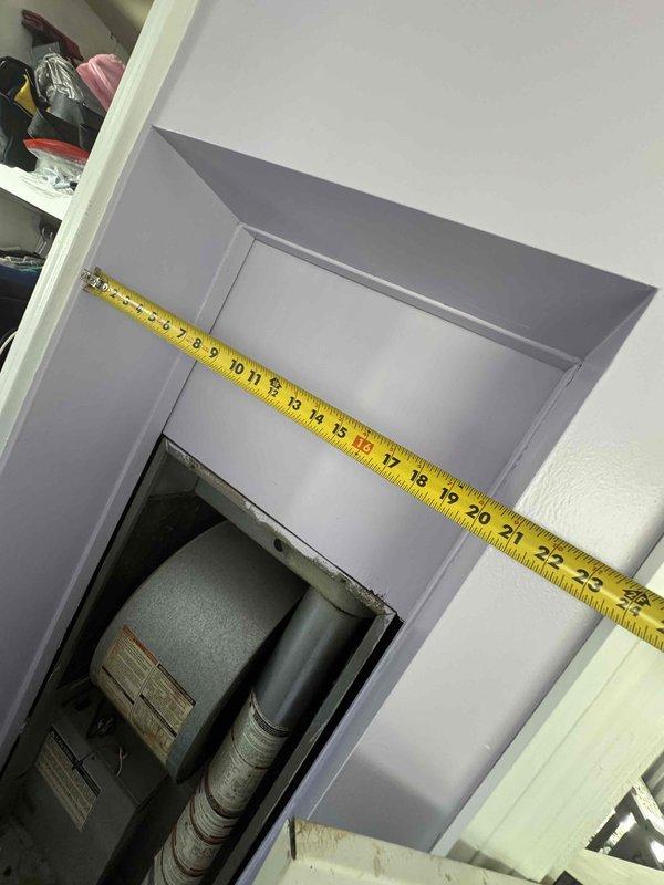 Completed full system estimate for residential HVAC replacement involving a 1998 furnace and failed air conditioning unit. System exhibited multiple failures including AC blowing hot air followed by complete heating failure approximately one week later. Assessed unusual dual-thermostat configuration connected to single furnace unit, with previous owners indicating separate thermostats for heating and cooling despite both units having full HVAC control capability. Documented existing equipment located in interior utility closet alcove and exterior condensing unit positioned on concrete pad against mobile home exterior. Measured installation space dimensions and photographed current system configuration including furnace with flexible ductwork connection and weathered outdoor AC unit. Provided comprehensive replacement options for complete heating and cooling system due to age of equipment and extent of failures making repair economically unfeasible.