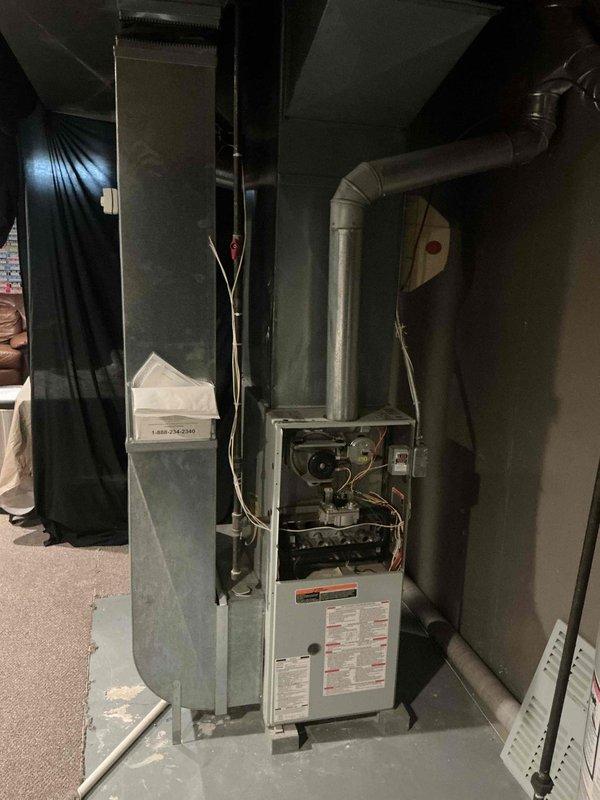 Conducted air conditioner replacement estimate for a 20-year-old existing system. Inspected current HVAC equipment in basement utility area, including furnace unit with exposed access panel and ductwork configuration. Documented existing mechanical room setup, noting water heater previously installed, and assessed space requirements for new AC system installation.