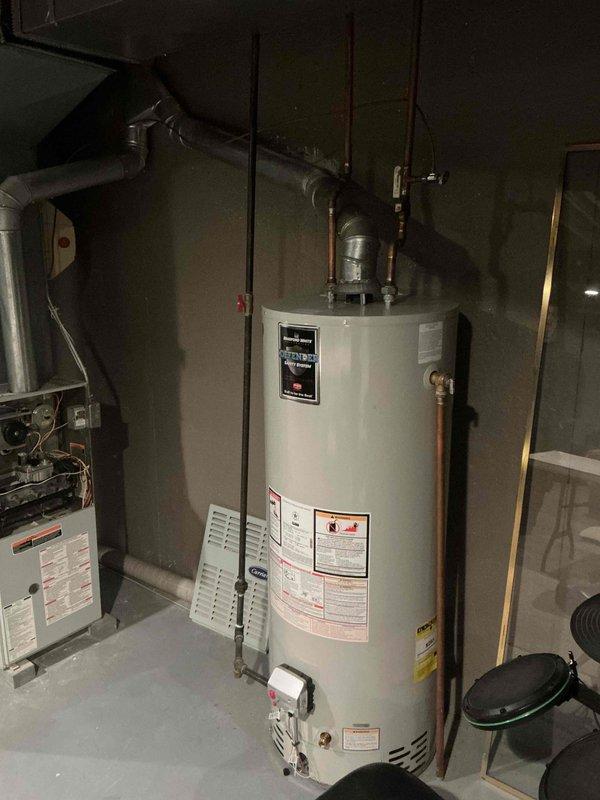 Conducted air conditioner replacement estimate for a 20-year-old existing system. Inspected current HVAC equipment in basement utility area, including furnace unit with exposed access panel and ductwork configuration. Documented existing mechanical room setup, noting water heater previously installed, and assessed space requirements for new AC system installation.