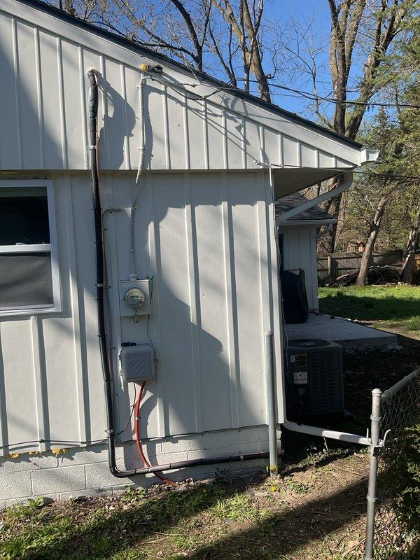 Completed full HVAC system installation including a 70,000 BTU furnace and 2-ton air conditioning unit with rear discharge configuration. Obtained mechanical and electrical permits prior to installation. Installed new outdoor condenser unit on concrete pad with proper refrigerant line connections, electrical disconnect box, and conduit runs mounted to building exterior. Ran insulated refrigerant lines from outdoor unit to indoor furnace location and completed all electrical connections per code requirements. Reconnected existing ductwork to new furnace and verified proper airflow. System tested and operational upon completion.