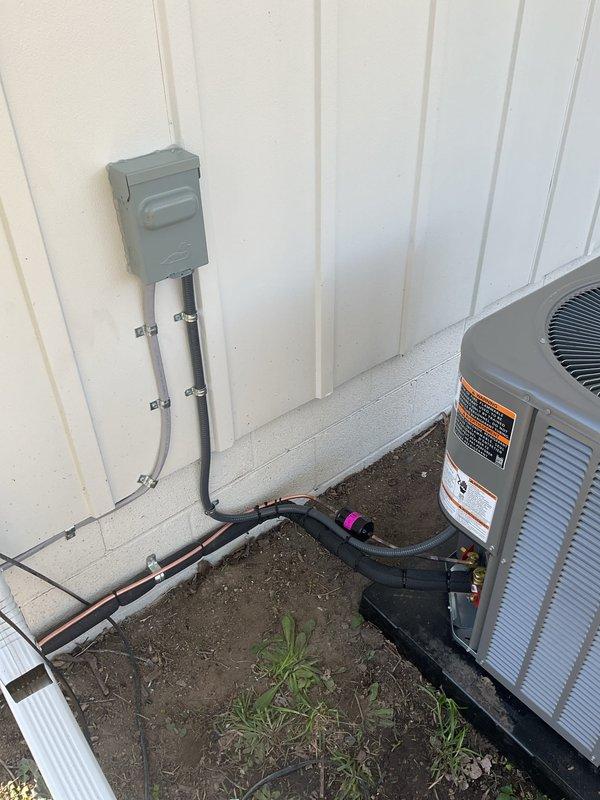 Completed full HVAC system installation including a 70,000 BTU furnace and 2-ton air conditioning unit with rear discharge configuration. Obtained mechanical and electrical permits prior to installation. Installed new outdoor condenser unit on concrete pad with proper refrigerant line connections, electrical disconnect box, and conduit runs mounted to building exterior. Ran insulated refrigerant lines from outdoor unit to indoor furnace location and completed all electrical connections per code requirements. Reconnected existing ductwork to new furnace and verified proper airflow. System tested and operational upon completion.