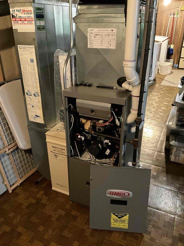 Conducted comprehensive assessment of existing 15-18 year old Lennox natural gas furnace and air conditioning system located in basement utility area. Evaluated current operational status of functioning equipment, documented existing installation configuration including ductwork connections, PVC venting, condensate drainage system, and electrical connections. Provided detailed replacement estimate options for complete HVAC system upgrade to address aging equipment concerns and improve energy efficiency.