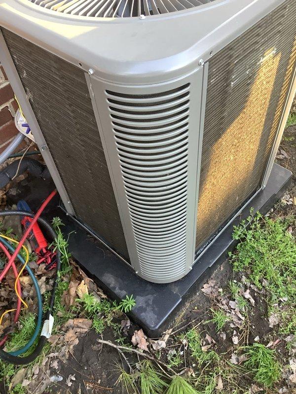 # HVAC Maintenance - Air Conditioning Unit

Performed routine annual maintenance on residential outdoor condensing unit. Conducted thorough inspection of equipment, noting significant dirt accumulation and weathering on exterior panels and condenser coil fins. The unit displayed heavy soiling with dark brown and grayish buildup throughout the fin section, indicating extended operation without recent cleaning.

Completed standard maintenance protocol including filter replacement and condenser pad inspection. The black rubber mounting pad was confirmed to be in serviceable condition providing adequate equipment support. Documented equipment condition through photographic records showing visible wear patterns, panel discoloration, and environmental debris accumulation around the unit base. Unit remains operational following maintenance completion.