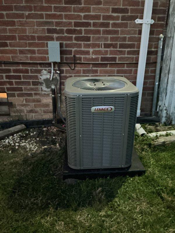 Completed full installation of 2-ton Lennox air conditioning system with matching evaporator coil at rear of property. Installed new outdoor condensing unit on pad against brick exterior wall with proper clearances, ran refrigerant lines and electrical connections through wall penetration to interior mechanical space, and mounted indoor evaporator coil with required condensate drainage. New dedicated electrical circuit was installed with disconnect box and proper conduit routing per code requirements. All mechanical and electrical permits were obtained prior to installation, system was pressure tested, evacuated, charged to manufacturer specifications, and verified operational with proper airflow and temperature differential across coil.