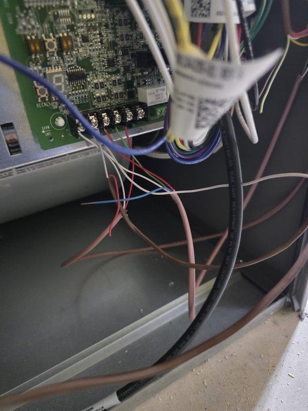 Responded to service call for air conditioning unit not turning on with flashing "A" error code on control board. Upon inspection of the 4-month-old outdoor unit, diagnosed control board fault indicated by error code display. Performed electrical testing using digital multimeter to verify voltage readings and circuit integrity at the control board terminals. Documented existing control board configuration and wiring connections prior to troubleshooting. Determined issue covered under parts and labor warranty due to equipment age. Advised on warranty claim process for defective control board replacement to restore system operation.