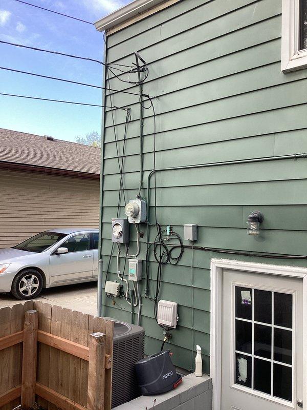 Responded to a partial power loss condition affecting the garage area. Upon arrival, conducted a comprehensive diagnostic evaluation of the electrical service equipment, including inspection of the exterior meter base, service entrance conductors, and associated distribution panels. Visually examined all exterior electrical components, conduit runs, junction boxes, and connection points for signs of damage, loose connections, or code violations. Verified proper operation of the main service disconnect and assessed the integrity of the overhead utility connection at the weather head. Documented the existing electrical installation configuration with photographs showing the complete service entrance assembly, metering equipment, and associated exterior wiring systems. Completed diagnostic assessment to identify the source of the power interruption and provided findings to facilitate necessary repairs.