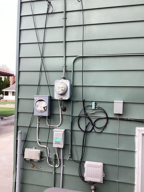 Responded to a partial power loss condition affecting the garage area. Upon arrival, conducted a comprehensive diagnostic evaluation of the electrical service equipment, including inspection of the exterior meter base, service entrance conductors, and associated distribution panels. Visually examined all exterior electrical components, conduit runs, junction boxes, and connection points for signs of damage, loose connections, or code violations. Verified proper operation of the main service disconnect and assessed the integrity of the overhead utility connection at the weather head. Documented the existing electrical installation configuration with photographs showing the complete service entrance assembly, metering equipment, and associated exterior wiring systems. Completed diagnostic assessment to identify the source of the power interruption and provided findings to facilitate necessary repairs.