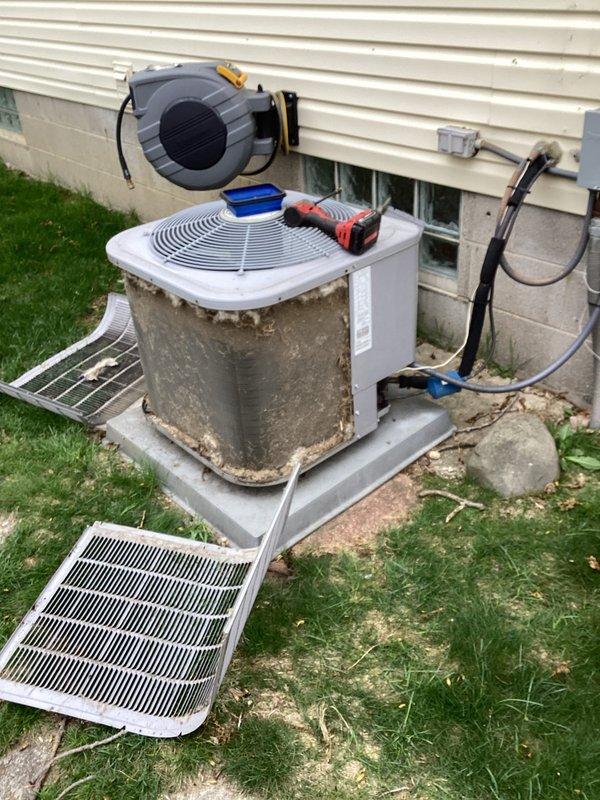 Performed annual cooling maintenance on outdoor condensing units. Removed and cleaned side panels and protective grilles, inspected refrigerant lines and electrical connections, and conducted diagnostic testing using digital meters to verify system performance. All components were reassembled and units were left in proper operating condition.