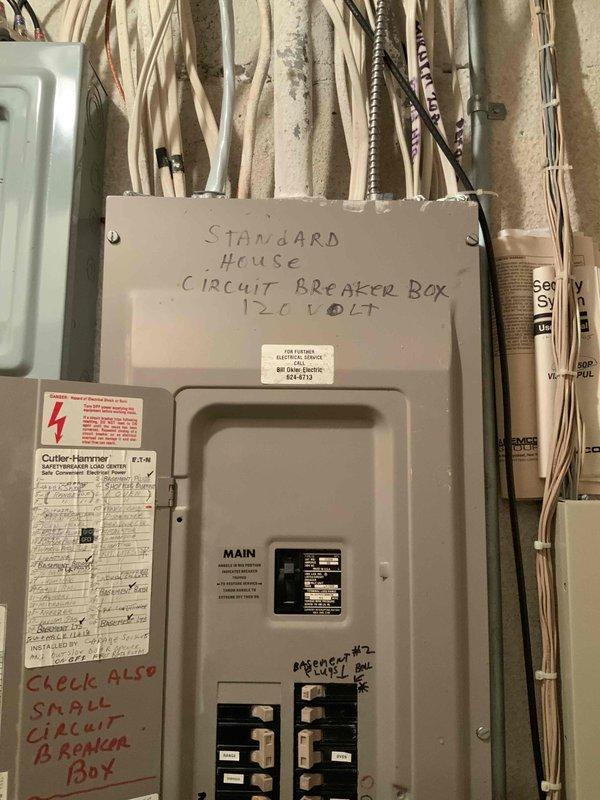 Conducted on-site assessment for mini split air conditioning system installation in master bedroom with no existing HVAC system present. Evaluated electrical infrastructure including main 120-volt circuit breaker panel and generator transfer switch configuration. Documented existing electrical capacity and panel layout to determine feasibility of dedicated circuit installation for mini split unit. Photographed electrical panels showing current circuit distribution with master bedroom circuit identified, as well as secondary load center with generator integration. Assessment confirmed adequate wall access and electrical service capacity for expedited mini split installation.