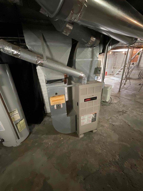 Conducted estimate for furnace replacement on 28-year-old existing heating system. Inspected current furnace unit, ductwork configuration, electrical panel capacity, and utility room layout to assess installation requirements. Documented existing equipment specifications and photographed current system setup including furnace, water heater proximity, electrical service panel, ductwork routing, and basement workspace conditions to provide comprehensive replacement proposal.
