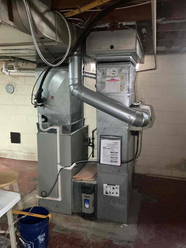 Conducted comprehensive assessment of existing residential HVAC system in basement utility area for full system replacement estimate. Evaluated current forced-air furnace, humidifier unit, ductwork configuration including flexible aluminum ducts, and overall mechanical infrastructure condition. Documented equipment specifications, existing installation layout, and utility connections to provide cost-effective replacement options for property sale preparation.