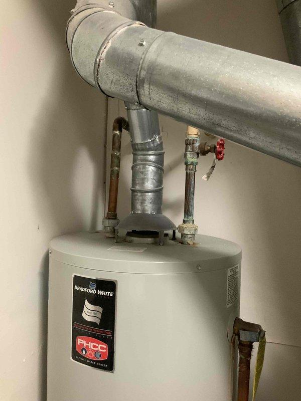 Conducted on-site assessment for complete HVAC system replacement, evaluating existing furnace, air conditioning unit, and Bradford White water heater in residential mechanical room. Documented current equipment configuration including ductwork dimensions and layout, photographed existing installations, and prepared comprehensive replacement estimates for new furnace, AC system, and standard water heater per homeowner's request.