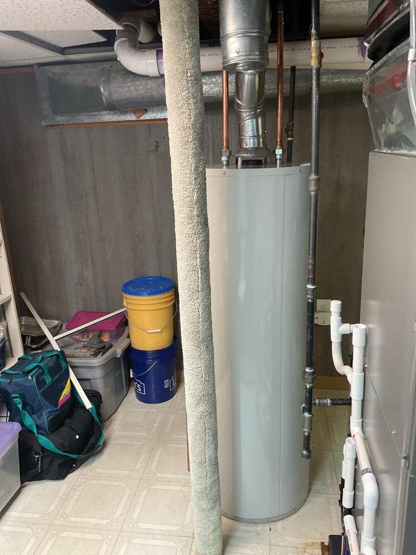 Completed installation of 40-gallon tanked water heater in basement utility area. Removed existing unit and installed new water heater with proper venting through metallic flue pipe, connected copper supply lines, and verified all plumbing connections for code compliance. All mechanical permits obtained prior to installation, system tested and operational upon completion.