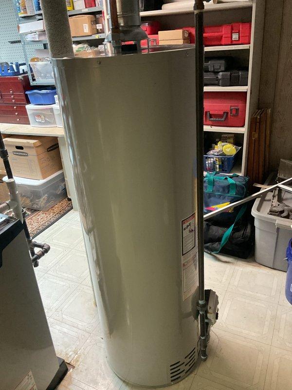 Completed installation of 40-gallon tanked water heater in basement utility area. Removed existing unit and installed new water heater with proper venting through metallic flue pipe, connected copper supply lines, and verified all plumbing connections for code compliance. All mechanical permits obtained prior to installation, system tested and operational upon completion.