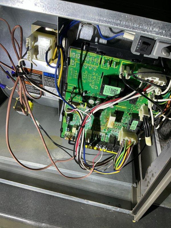 Responded to no-heat call with service alert code 29 displayed on thermostat. Upon arrival, confirmed furnace was not operating and no airflow was present from supply registers. Removed furnace cabinet panels to access control board assembly and internal components for diagnostic inspection. Examined multi-board integrated control system, including main control board, motor control module, and safety circuit boards. Inspected all wire harness connections, terminal blocks, and electrical connections for loose contacts, corrosion, or damage. Verified transformer operation and checked for proper voltage supply to control circuits. Inspected blower motor assembly and capacitor for operational status. Examined evaporator coil cabinet and verified coil condition, noting normal dust accumulation consistent with system age. Checked condensate drainage system including PVC drain lines and condensate pump assembly for proper operation and clearance. Photographed control board assembly showing mu