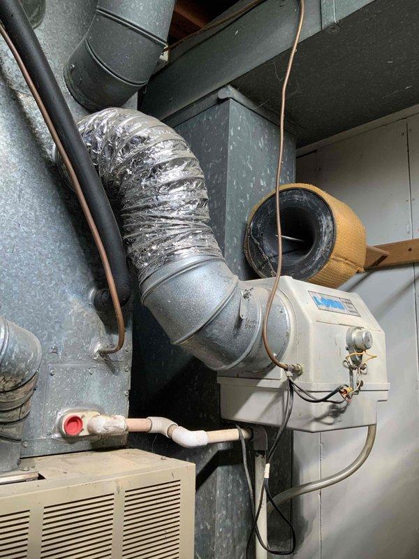 Conducted on-site evaluation of existing residential air conditioning system for replacement estimate. Assessed current HVAC installation in basement utility area, including air handler, ductwork configuration, humidifier integration, and associated plumbing connections. Documented existing equipment condition and spatial requirements through detailed photography to develop comprehensive replacement proposal for aging cooling system.