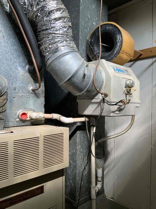 Conducted on-site evaluation of existing residential air conditioning system for replacement estimate. Assessed current HVAC installation in basement utility area, including air handler, ductwork configuration, humidifier integration, and associated plumbing connections. Documented existing equipment condition and spatial requirements through detailed photography to develop comprehensive replacement proposal for aging cooling system.